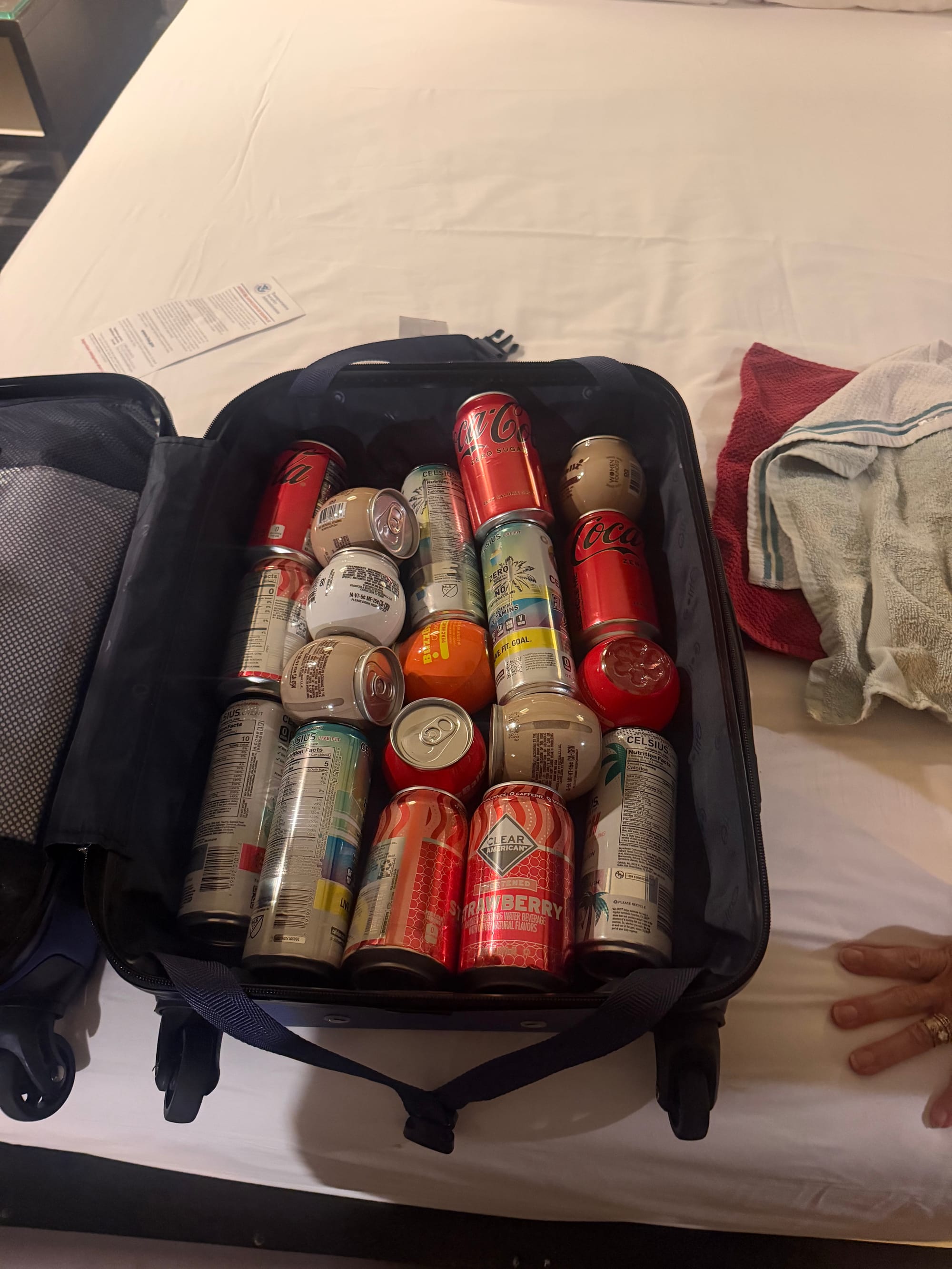 A carry-on full of soda cans