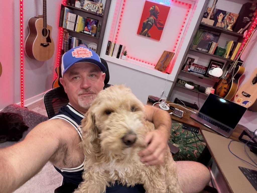 Mike Baker in his home studio with his dog Gus