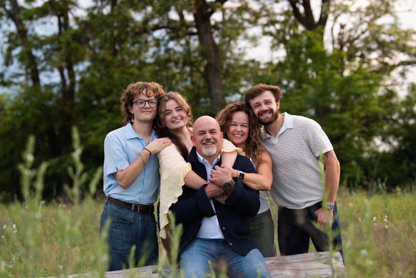 Mike Baker with his wife Kellie and their three kids, Jacob, Cameron, and Sammie, outdoors in a field