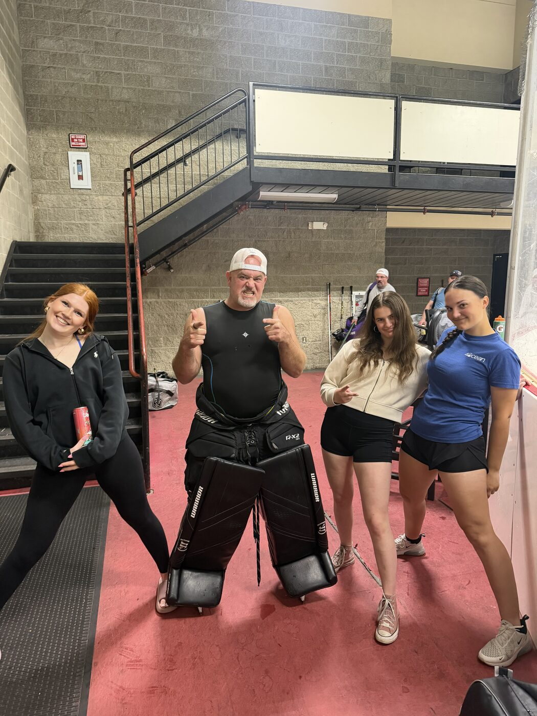Mike with three players from the Inland Northwest Girls Hockey Foundation at the rink