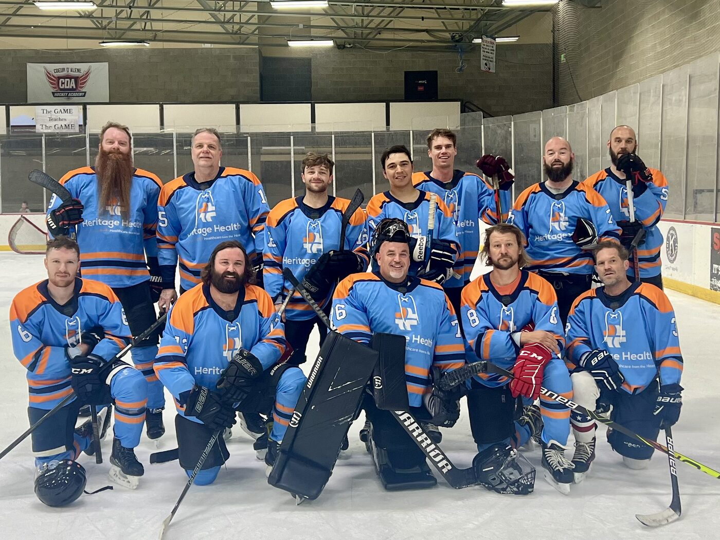 The Heritage Health beer league team posing on the ice