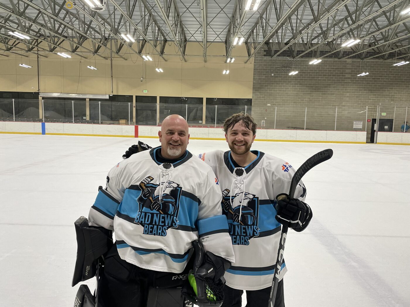 Mike and his son Jake in matching Bad News Bears jerseys on the ice