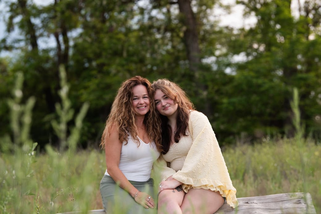 Kellie and Samantha Baker sitting together in a field